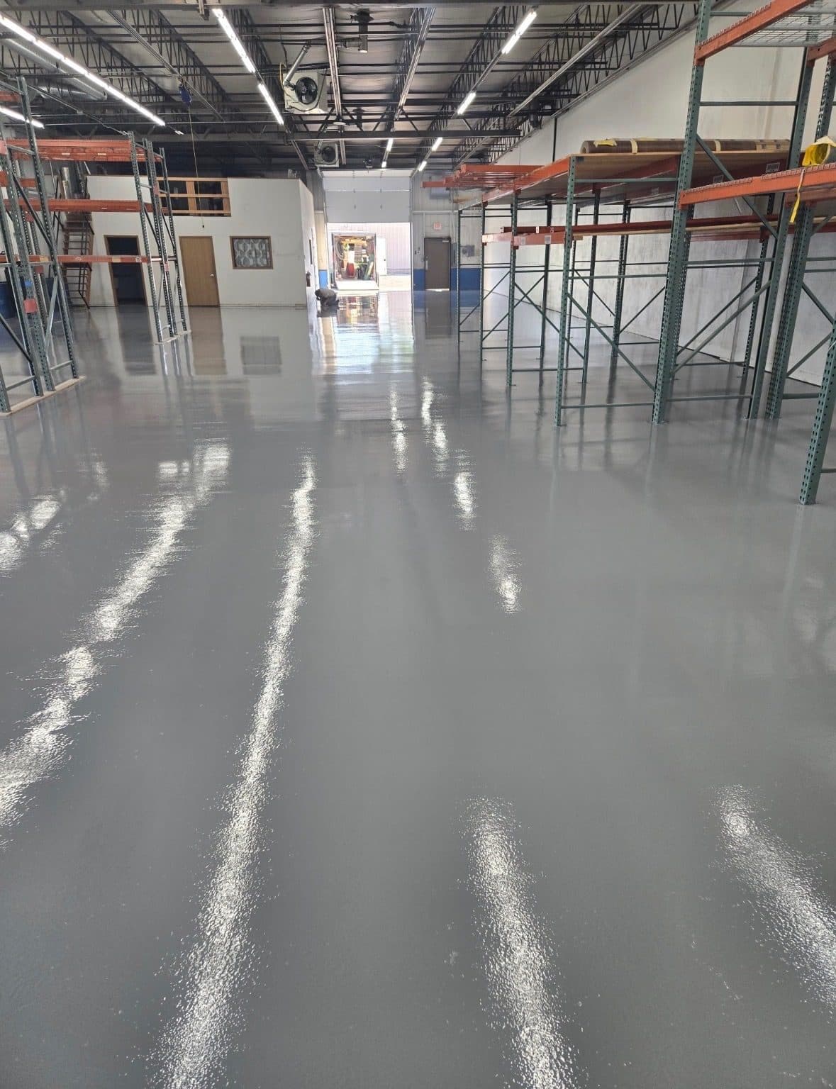 Gray high-build polyaspartic coating on a commercial warehouse floor