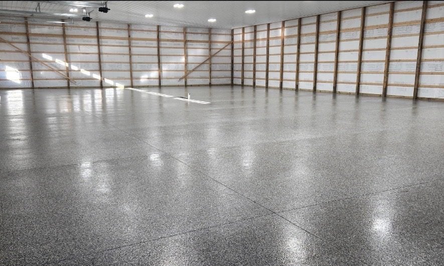 Gray, black and white flake floor filling a large pole barn interior