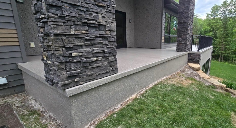 Luxury stone-column porch with polyaspartic coating